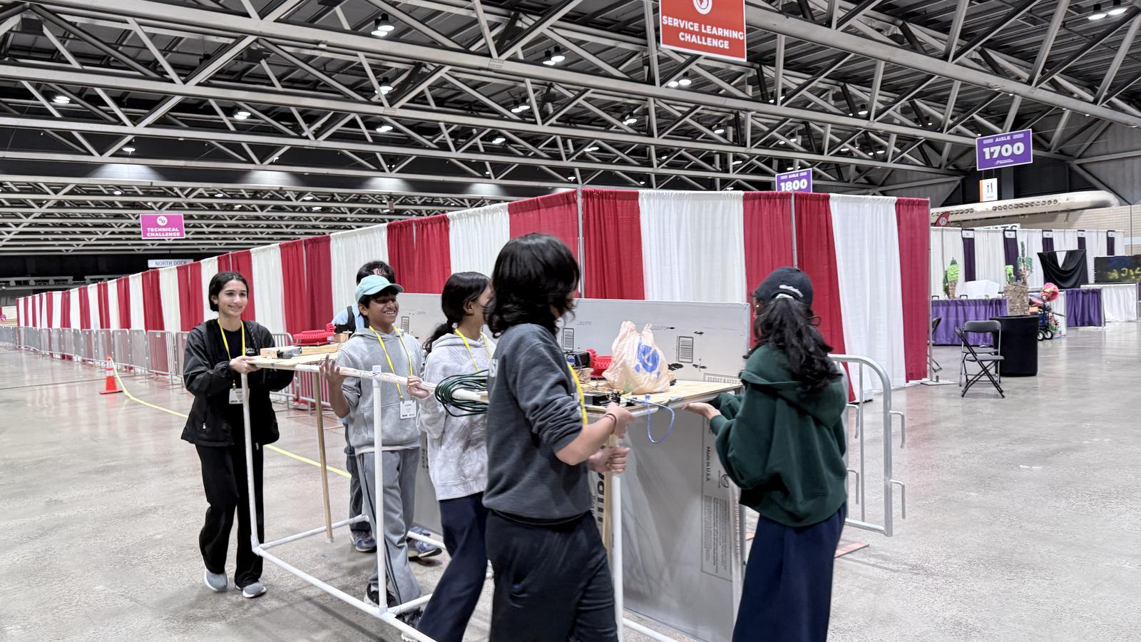 Team carrying equipment at Global Finals convention center